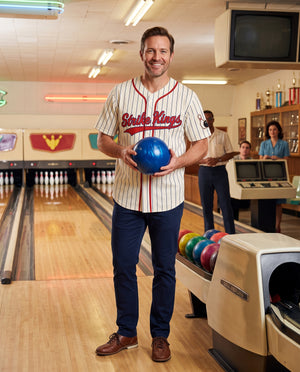 Man wearing the Strike Kings bowling baseball jersey at a retro bowling alley